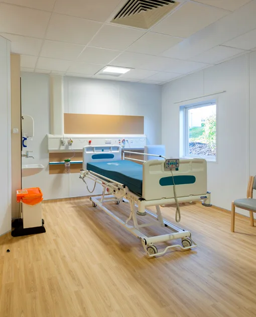 Hospital room with light wood-look vinyl floor