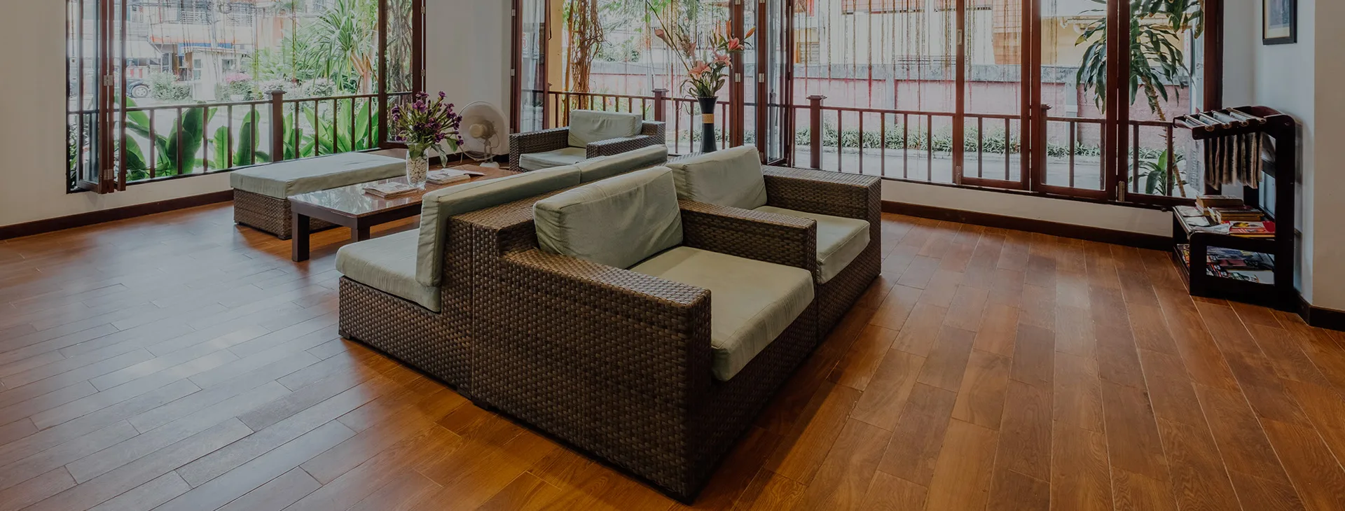 Open living lounge with wooden flooring and garden views
